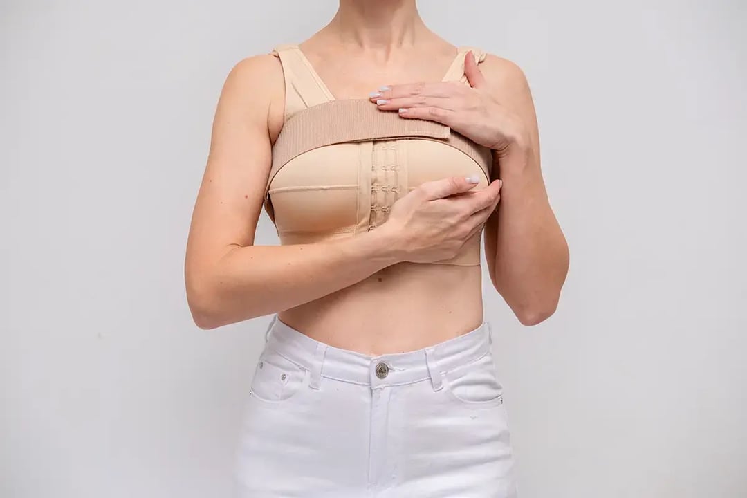 woman patient in post surgical compression bra implants stabilizer bra after plastic surgery